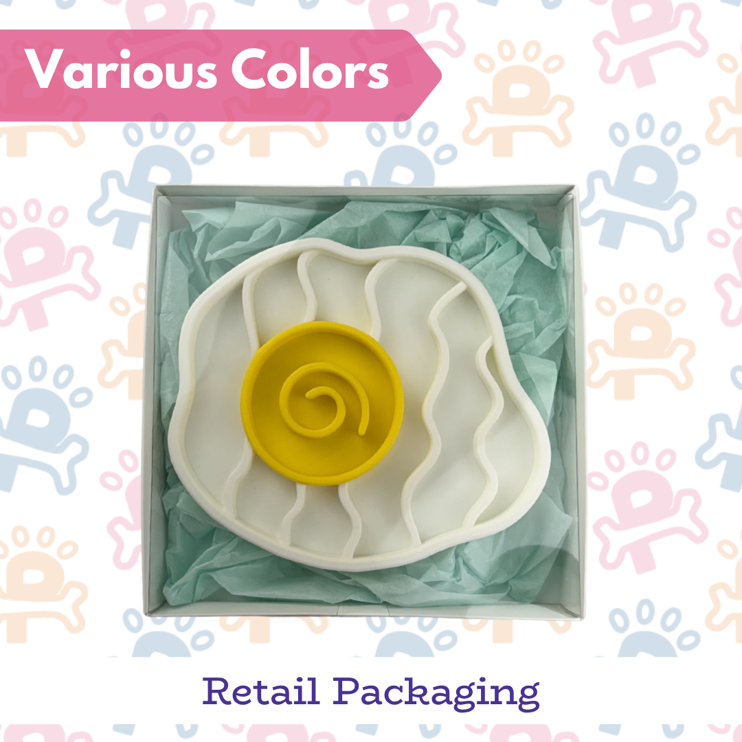 Cookie cutter with yellow center and white shell shape in packaging on a colorful background