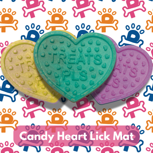An array of colorful candy heart-shaped lick mats for dogs, displayed on a background patterned with dog motifs.