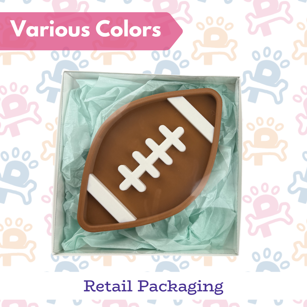Football-shaped object in a box with 'Various Colors' text on a patterned background