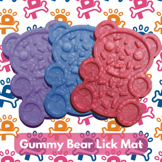 Two gummy bear lick mats for dogs, one in blue and one in red, with a pattern of gummy bears in the background.