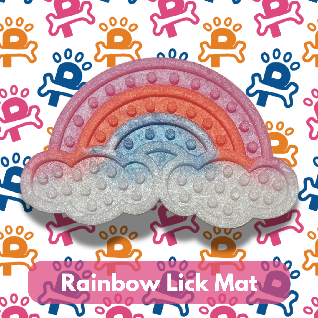 A rainbow-colored lick mat for dogs with a textured surface, displayed on a background with colorful patterns.