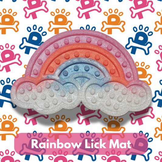 A rainbow-colored lick mat for dogs with a textured surface, displayed on a background with colorful patterns.