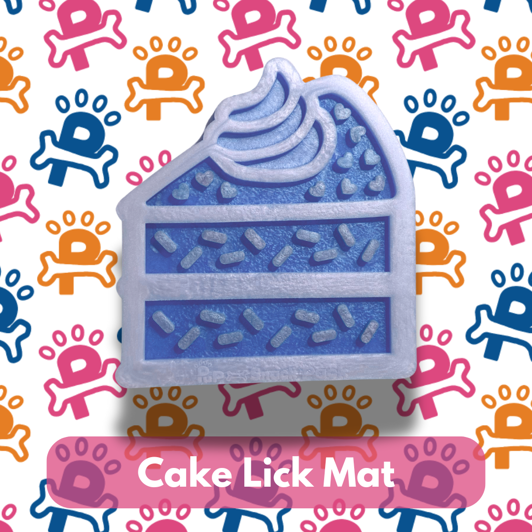 Cake-shaped lick mat with blue icing and sprinkles on a colorful background with paw prints.